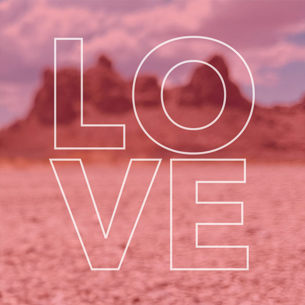 The letters LOVE are formed in a square shape over a desert landscape background with a pink hue.