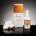 Mojave Myst luxury box and spray bottle with coconut slices on a black reflective surface.
