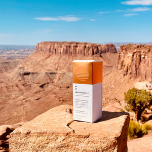 
                  
                    A luxury box of Mojave Myst Molecular Spray Deodorant resting on a red rock. A desert mesa and buttes are in the background.
                  
                