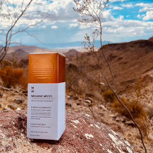 
                  
                    A luxury box of Mojave Myst Molecular Spray Deodorant on a red rock in a desert landscape.
                  
                